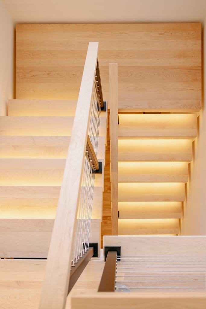 Interior wood staircase with step lights